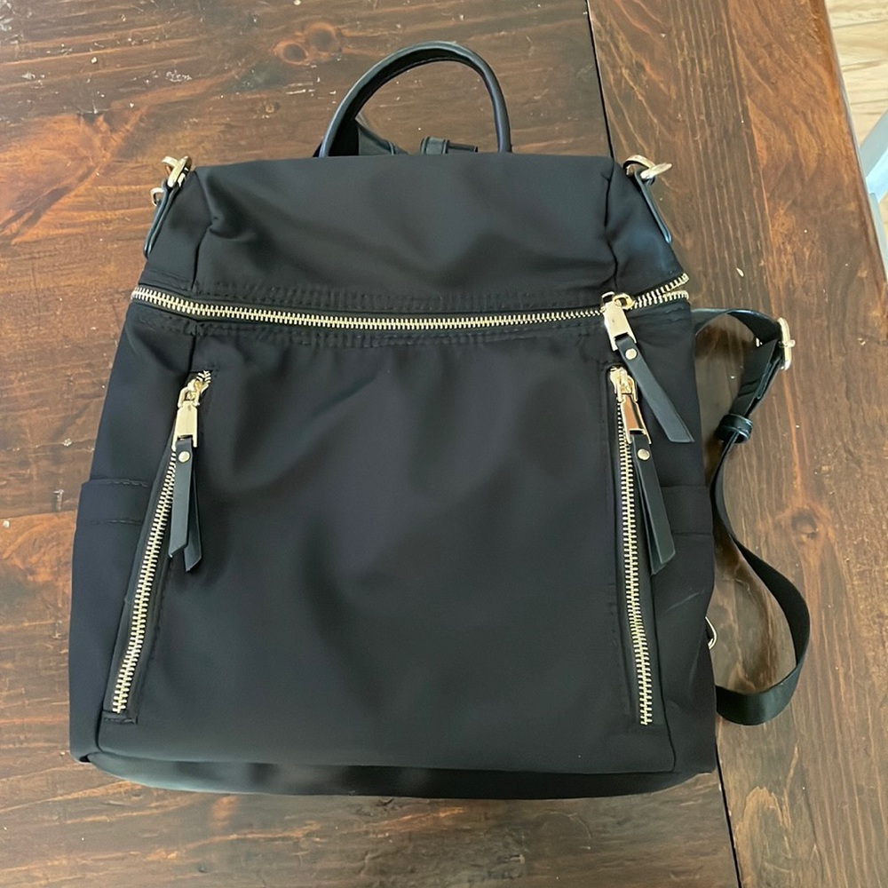 Backpack purse with shoulder strap and backpack straps. Black with gold zippers